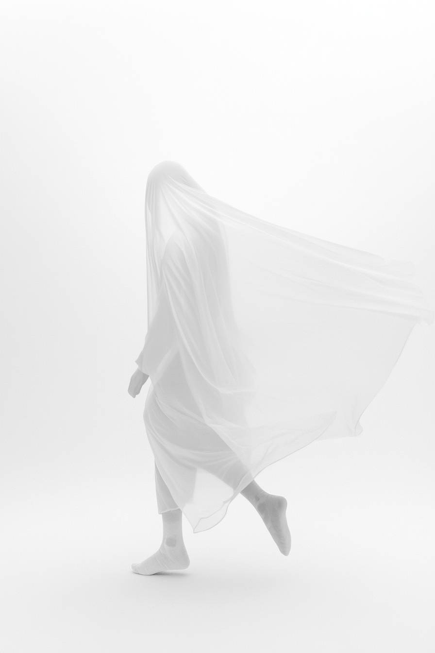 A ballerina performs a windmill dance in a minimalist white space, wearing oversized street-style clothing, showcasing elegance and fluidity.